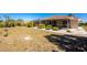 Spacious backyard featuring a screened lanai, lush tropical plants and rock landscaping at 5441 Farley St, Port Charlotte, FL 33981