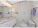 Bright bathroom features a white vanity, marble countertop, and updated fixtures at 5441 Farley St, Port Charlotte, FL 33981