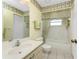 Bathroom with a vanity, matching wallpaper, and a shower-tub combo at 5441 Farley St, Port Charlotte, FL 33981
