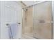 Bathroom showcasing a glass-enclosed shower with a built-in seat and neutral finishes at 5441 Farley St, Port Charlotte, FL 33981