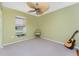 Bright bedroom features a large window and a unique ceiling fan at 5441 Farley St, Port Charlotte, FL 33981