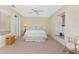 Cozy bedroom features a ceiling fan, window seat, and neutral carpet at 5441 Farley St, Port Charlotte, FL 33981