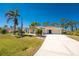 Charming single-story home with a long driveway and lush landscaping at 5441 Farley St, Port Charlotte, FL 33981