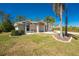 Landscaped home exterior featuring a manicured lawn and palm trees in Florida at 5441 Farley St, Port Charlotte, FL 33981