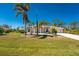 Inviting home exterior with palm trees, manicured lawn, and a spacious driveway at 5441 Farley St, Port Charlotte, FL 33981