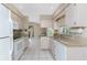 Eat-in kitchen featuring granite countertops, white appliances, and a large window at 5441 Farley St, Port Charlotte, FL 33981