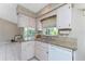 Kitchen with granite counters, and stainless sink plus a view of the backyard at 5441 Farley St, Port Charlotte, FL 33981