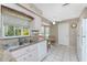 Bright kitchen features granite counters, stainless steel sink, and views of backyard at 5441 Farley St, Port Charlotte, FL 33981