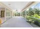 Extended lanai featuring screened-in patio with a fan, overlooking the lush greenery at 5441 Farley St, Port Charlotte, FL 33981
