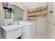 Functional laundry room with a utility sink, washer, dryer, and ample storage baskets at 5441 Farley St, Port Charlotte, FL 33981