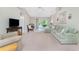 Spacious living room features neutral walls, plush carpet, and large glass doors opening to the outdoors at 5441 Farley St, Port Charlotte, FL 33981