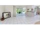 Bright living space with tile floors, sliding glass doors to patio, and kitchen bar at 5441 Farley St, Port Charlotte, FL 33981
