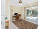 Home office with a sliding door, a computer, and neutral tile flooring at 5441 Farley St, Port Charlotte, FL 33981