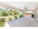 Spacious screened-in patio featuring a ceiling fan and ample space for outdoor seating and entertaining at 5441 Farley St, Port Charlotte, FL 33981
