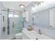 Modern bathroom with glass-enclosed shower, and white vanity, offering a clean and bright aesthetic at 613 Chestnut Ln, Englewood, FL 34223