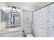 Bathroom featuring a granite countertop, elegant mirror, and shower with curtain at 613 Chestnut Ln, Englewood, FL 34223