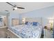 Comfortable bedroom featuring a decorative headboard, blue accents, and plenty of natural light at 613 Chestnut Ln, Englewood, FL 34223