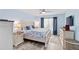 Cozy bedroom with blue accents, decorative headboard, and a spacious layout at 613 Chestnut Ln, Englewood, FL 34223