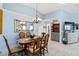 Charming dining room featuring a wooden table, elegant chandelier, and built-in bar area at 613 Chestnut Ln, Englewood, FL 34223