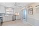 Clean kitchen boasting white cabinets, stainless steel appliances, and ample natural light at 613 Chestnut Ln, Englewood, FL 34223
