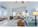 Bright living room featuring stylish decor, vaulted ceiling and open layout at 613 Chestnut Ln, Englewood, FL 34223