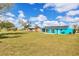 Bright blue home with a huge backyard, offering plenty of space for recreation and relaxation at 6264 Drucker Cir, Port Charlotte, FL 33981