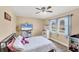 Bedroom with TV and a large window overlooking the neighborhood at 6264 Drucker Cir, Port Charlotte, FL 33981