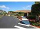 Elegant clubhouse entrance featuring a well-manicured walkway surrounded by vibrant landscaping at 6264 Drucker Cir, Port Charlotte, FL 33981