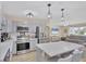 Open-concept kitchen featuring modern appliances, ample counter space, and seamless flow into the adjacent living area at 6264 Drucker Cir, Port Charlotte, FL 33981