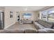 Living room with modern flooring, neutral walls, comfortable seating, and access to the kitchen and bedroom areas at 6264 Drucker Cir, Port Charlotte, FL 33981