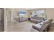 Sun-filled living room showcasing modern flooring, a large window with a view, and comfortable seating at 6264 Drucker Cir, Port Charlotte, FL 33981