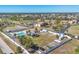Aerial view of a community pool surrounded by a fence, RV parking, green space and lush landscaping at 6699 San Casa Dr # Q3, Englewood, FL 34224