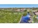 Aerial view of the community showing a canal, dock, and landscaping at 6699 San Casa Dr # Q3, Englewood, FL 34224