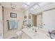 Bright bathroom features a vanity with a large mirror, a toilet, and a shower/tub combination at 6699 San Casa Dr # Q3, Englewood, FL 34224
