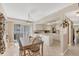 Open dining area with a table, chandelier, and view of the kitchen, creating a welcoming space at 6699 San Casa Dr # Q3, Englewood, FL 34224