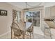 Dining area featuring a table with six chairs, pendant lighting, and sliding glass doors to the exterior at 6699 San Casa Dr # Q3, Englewood, FL 34224