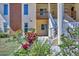 Close-up of a condo exterior, with a stairway, well-kept landscaping and colorful flowers at 6699 San Casa Dr # Q3, Englewood, FL 34224