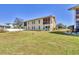Back exterior of home with a spacious yard and screened-in porch at 6699 San Casa Dr # Q3, Englewood, FL 34224