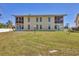 Backyard view of a residential property, featuring a large grass area at 6699 San Casa Dr # Q3, Englewood, FL 34224