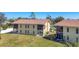 Back exterior of home with a spacious yard and screened-in porch at 6699 San Casa Dr # Q3, Englewood, FL 34224