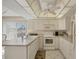 Bright kitchen with white cabinets, modern appliances, and a view to the outdoors at 6699 San Casa Dr # Q3, Englewood, FL 34224