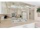 Bright kitchen featuring white cabinets, modern appliances, and a double basin sink at 6699 San Casa Dr # Q3, Englewood, FL 34224