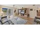 Open-concept living room flowing to outdoor screened room with stylish nautical-themed rug at 6699 San Casa Dr # Q3, Englewood, FL 34224