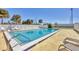 Community swimming pool with lounge chairs, pristine water, and well-maintained landscaping at 6699 San Casa Dr # Q3, Englewood, FL 34224