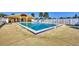 Community swimming pool with lounge chairs, pristine water, and clubhouse at 6699 San Casa Dr # Q3, Englewood, FL 34224