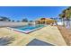 Community swimming pool with lounge chairs, pristine water, and clubhouse at 6699 San Casa Dr # Q3, Englewood, FL 34224