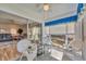 Cozy sunroom with white wicker furniture and sliding glass doors to the main living area at 6699 San Casa Dr # Q3, Englewood, FL 34224