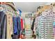 Well-organized walk-in closet features shelving, hanging rods, and ample storage space for clothes and accessories at 6699 San Casa Dr # Q3, Englewood, FL 34224