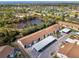 Aerial view of a condo community, with covered parking near pond and nature area at 6796 Gasparilla Pines Blvd # 40, Englewood, FL 34224