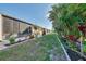 Expansive backyard featuring tropical plants, a patio, and serene landscaping at 6796 Gasparilla Pines Blvd # 40, Englewood, FL 34224